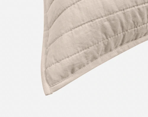 Close-up on the light flanged edge on the corner of our Linen Cotton Euro Sham in Flax.