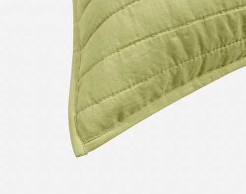 Close-up on the light flanged edge on the corner of our Linen Cotton Euro Sham in Green.