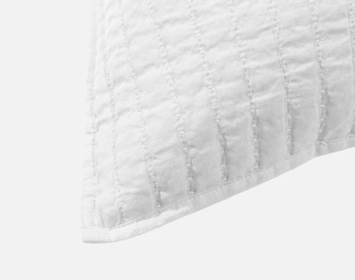 Close-up on the light flanged edge on the corner of our Linen Cotton Square Cushion Cover in White.