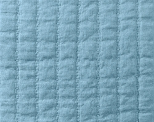 Close-up on the textural quilted lines on our Linen Cotton Square Cushion Cover in Lake.