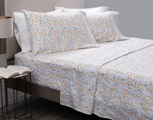 Flower Field Organic Cotton Sheet Set draped over a bed.