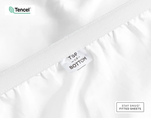 Close-up of a tag on the elastic of our BeechBliss TENCEL™ Modal Fitted Sheet in White to show a tag saying "Top" and "Bottom".