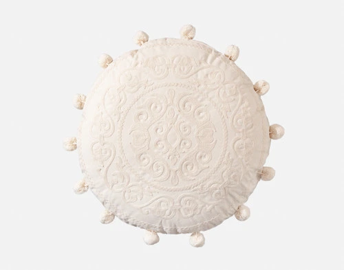 Front view of our Embroidered Round Cushion sitting against a solid white background.