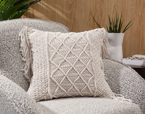 Front view of our Macramé Square Cushion Cover sitting back in a grey chair.