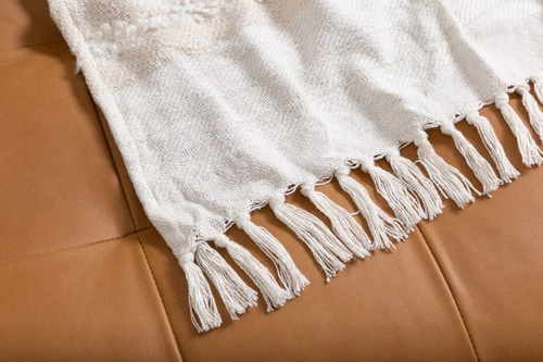 Close-up on the hemmed border corner on our Artisanal Throw in Naya.