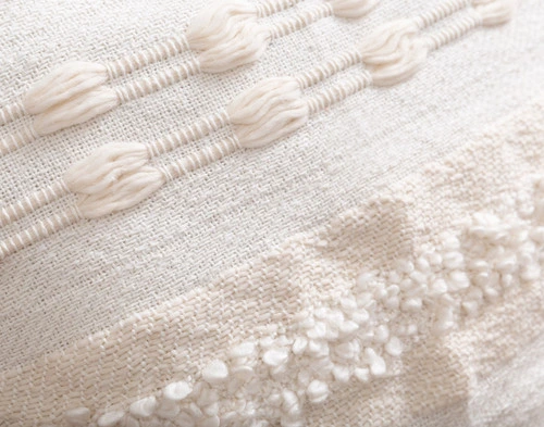 Close-up on the detailed hand woven pattern on our Naya Artisanal Cushion.