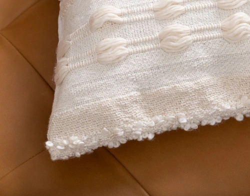 Close-up on the corner of our Naya Artisanal Cushion to show its tufted border.