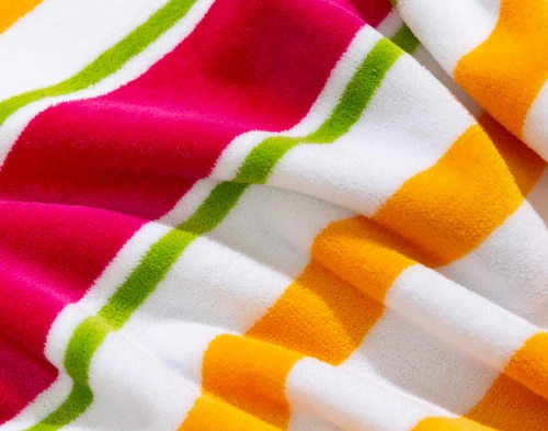 Close-up on the red, green, and orange pattern on our Capri Cotton Beach Towel.