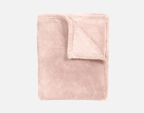 Our Velvet Plush Throw in Peony folded neatly into a tidy square.