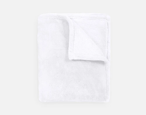 Our Velvet Plush Throw in Magnolia folded neatly into a tidy square.