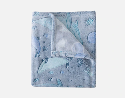 Top view of our Whale Pod Glow in the Dark Fleece Throw folded into a tidy square against a solid white background.