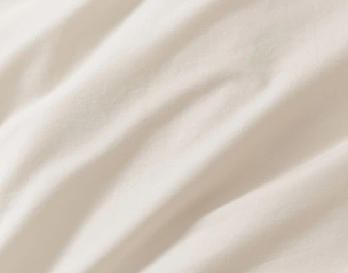 Close-up on the tufted cotton chenille appliqué design on our Sonrisa Duvet Cover.