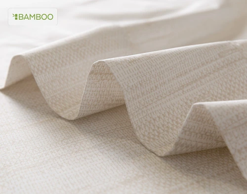 Flat sheet for our Bamboo Cotton Sheet Set in Crosshatch ruffled lightly over a matching smooth surface.