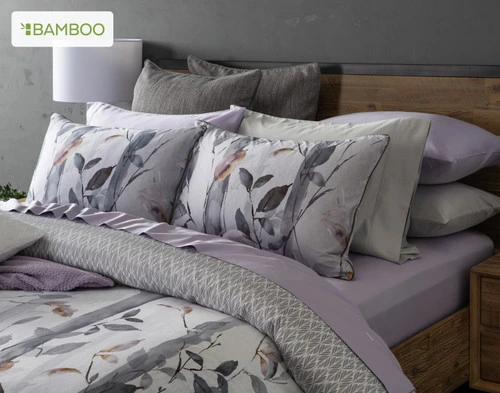 Closer angled view of our Tamarak Duvet Cover with its coordinating euro sham dressed with Light purple Wisteria sheets