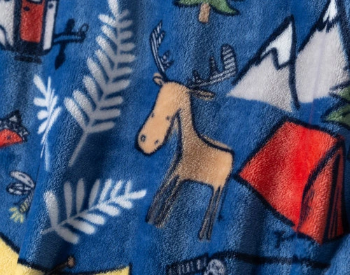 Close-up of the tent, mountain, and animal pattern and cozy fleece surface on our Adventure Camp Kids' Fleece Throw.