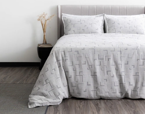 Front view of our Centro Duvet Cover dressed over a king bed in a plain white bedroom.