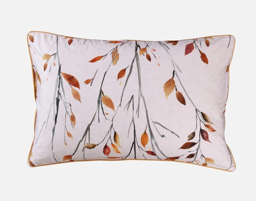 Front view of our Saturna Pillow Sham with leaf branch pattern and gold piping sitting against a solid white background.