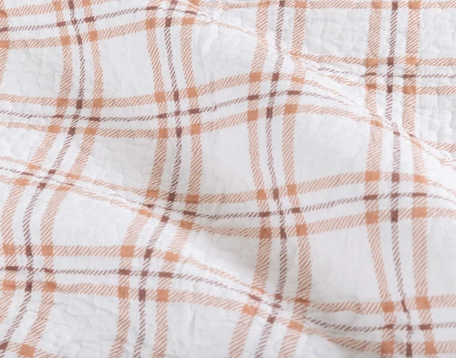 Close-up on the copper orange gingham reverse on our Forest Floor Cotton Quilt Set.