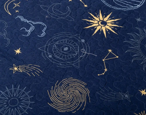 Close-up on the pattern of our Solar System Cotton Quilt Set showing classic constellations, stars, and black holes over a midnight blue background.