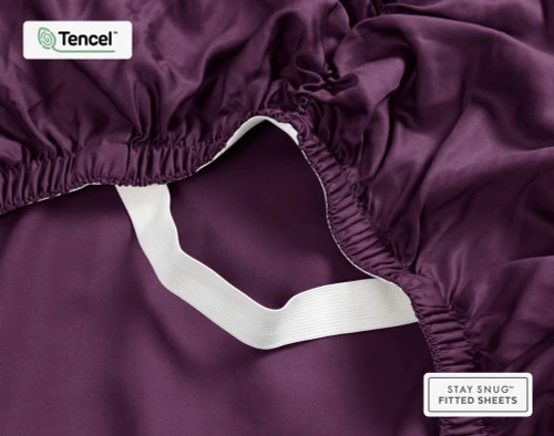 Close-up on the ruffled corner loosely resting on our BeechBliss TENCEL™ Modal Fitted Sheet in Plum.