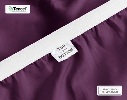 Close-up of Top & Bottom tag on the elastic of our BeechBliss TENCEL™ Modal Fitted Sheet in Plum.