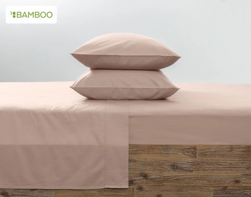 Two of our Bamboo Cotton Pillowcases in Frosted Berry Pink stacked on top of each other on a coordinating pink bed.