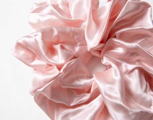 Close-up on the lustrously soft and ruffling surface on our Mulberry Silk Oversized Scrunchie in Blush.