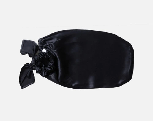 Front view of our Mulberry Silk Bun Cover in Black sitting empty over a solid white background.