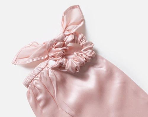 Close-up on the scrunchie opening on our Mulberry Silk Bun Cover in Blush.