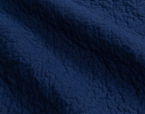 Close-up on the solid navy blue reverse on the back of our Harrison Cotton Quilt Set.