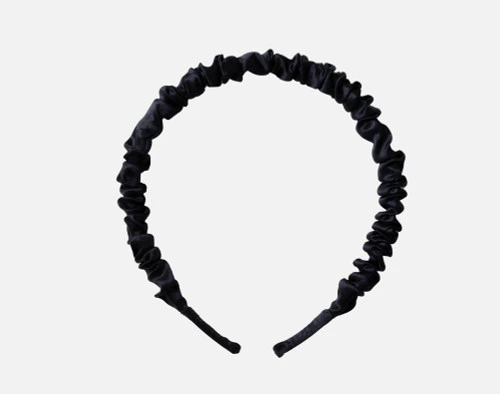 Front view of our Mulberry Silk Wrapped Hairband in Black resting on a solid white background.