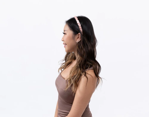 Side view of a woman wearing our Mulberry Silk Wrapped Hairband in Blush.