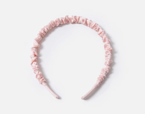 Front view of our Mulberry Silk Wrapped Hairband in Blush resting on a solid white background.