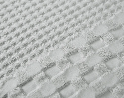 Close-up view of the mixed waffle textures on our Waffle Cotton Euro Sham in Silver.