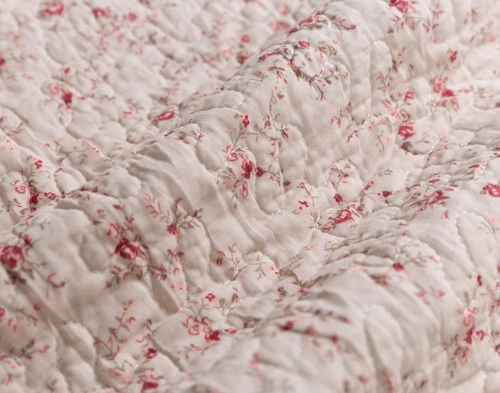 Close-up on the floral vine pattern on the back of our Misha Cotton Quilt Set.