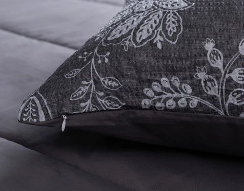 Close-up on the corner and zipper enclosure of a coordinating pillow sham from our Janus Comforter Set.