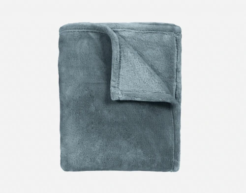 Our Velvet Plush Throw in Spruce folded neatly into a tidy square.