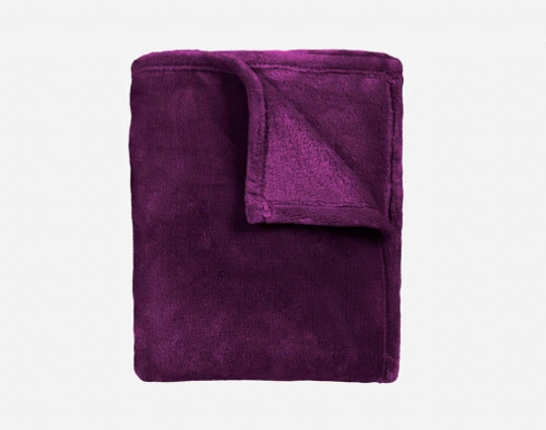 Our Velvet Plush Throw in Purple folded neatly into a tidy square.