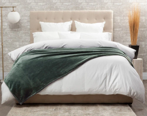 Front view of our Cashmere Touch Fleece Blanket in Balsam draped over a tidy white bed.