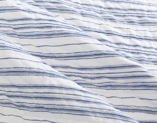 Close-up on the horizontal uneven striped reverse on the backing of our Frankie Cotton Quilt Set.