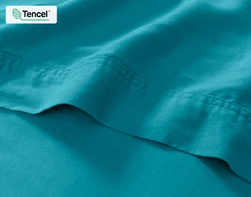 Close-up on the flat sheet of our Hemp Touch Sheet Set in Lake Blue to show its soft surface and cuff.