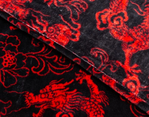 Close-up on the folded edge on our Lucky Dragon Throw in Red Luck.