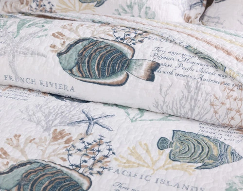 Rolled up top edge on our Marella Cotton Quilt Set to show its swimming flounders and encyclopedia-style sea facts.