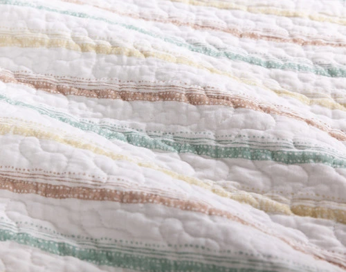 Close-up on the brown and blue striped reverse on our Marella Cotton Quilt Set.