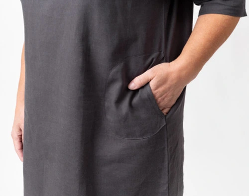 Close-up of a hand entering the pocket on the side of our Linen Blend Lounge Tunic in Black Pearl.