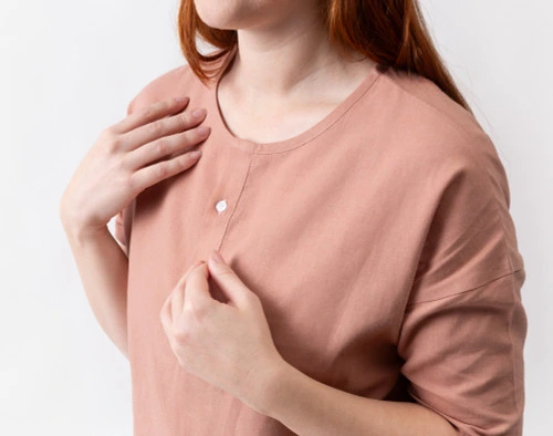 Close-up on the buttoned collar on the front of our Linen Blend Lounge Tunic in Clay.