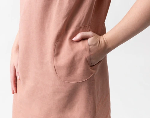 Close-up of a hand entering the pocket on the side of our Linen Blend Lounge Tunic in Clay.