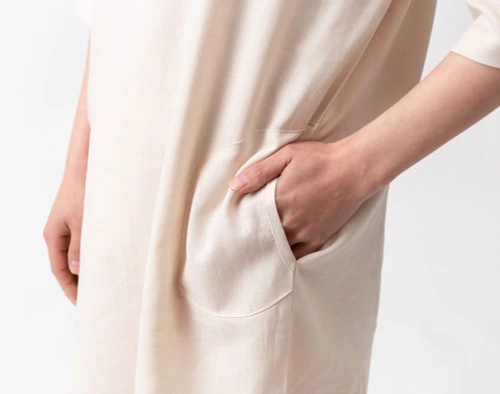 Close-up of a hand entering the pocket on the side of our Linen Blend Lounge Tunic in Stone.