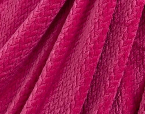 Close-up on the ruffled fabric on our Chevron Plush Throw in Fuchsia to show its soft surface.