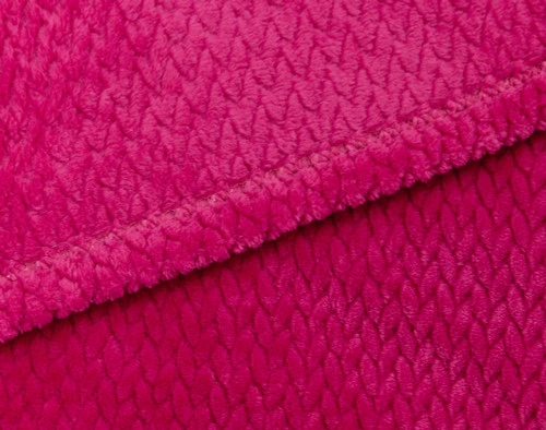 Close-up on the hemmed border on our Chevron Plush Throw in Fuchsia to show its reverse and front together.